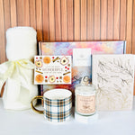 This A Loyal Society curated gift set is a beautiful way to celebrate fall birthdays, Thanksgiving and special occasions . It includes a lightweight cream-colored throw blanket, a chic plaid mug with a gold tone handle, a Vanilla Chai scented candle, a gold tone embossed linen notebook and a chic "It's the most wonderful time of the year" greeting card that is blank inside for your gift message.