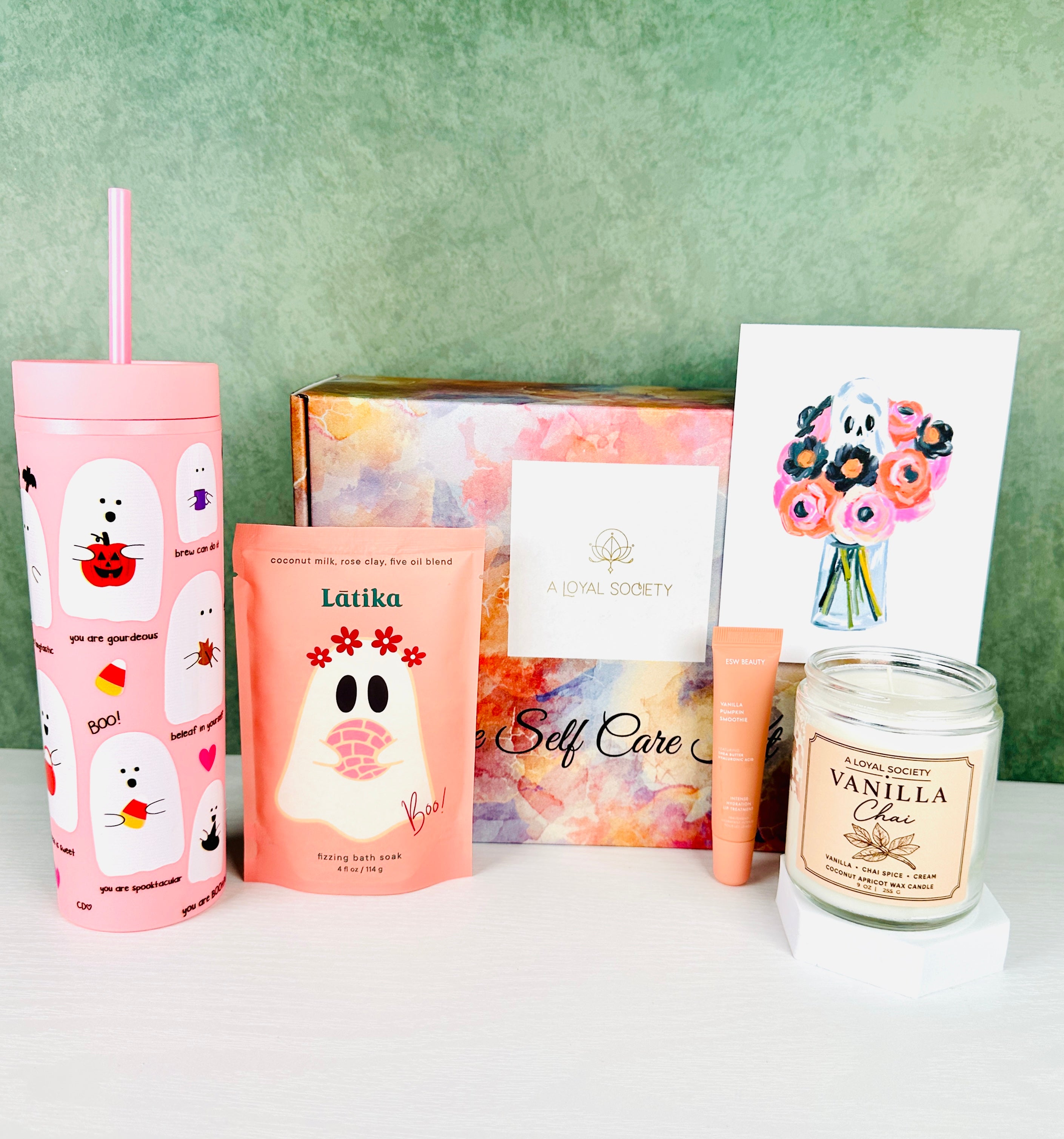 The A Loyal Society Pink Halloween Boo Box Giftset is a fun twist on traditional Halloween colors and is perfect for those who love all things pink! The set includes a pink friendly ghost-themed tumbler with a straw, pink bath soaking salts, a pumpkin flavored lip gloss, a Vanilla Chai scented candle and an adorable ghost themed greeting card that is blank inside for your gift message.