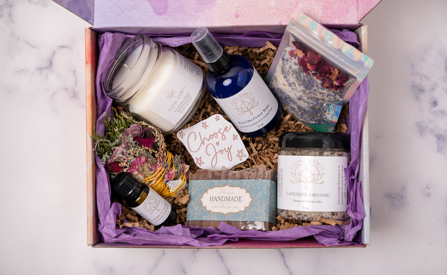 Photo Images of Self Care Everyday Gift Box By A Loyal Society Featuring Relaxation Candle, Floral Bath Soak, Sage Cleansing and Meditation Wand, Flower Water Spray, All Natural Soap Bar and Lavender and Rose Spa Salts. Self Care Kit